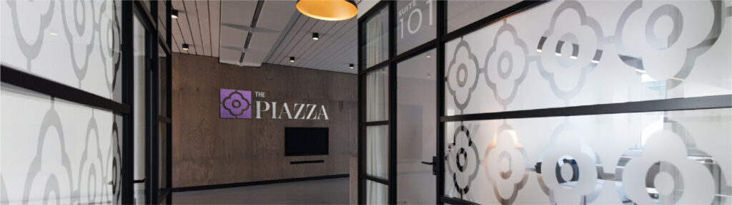 The Piazza logo signage in a hallway