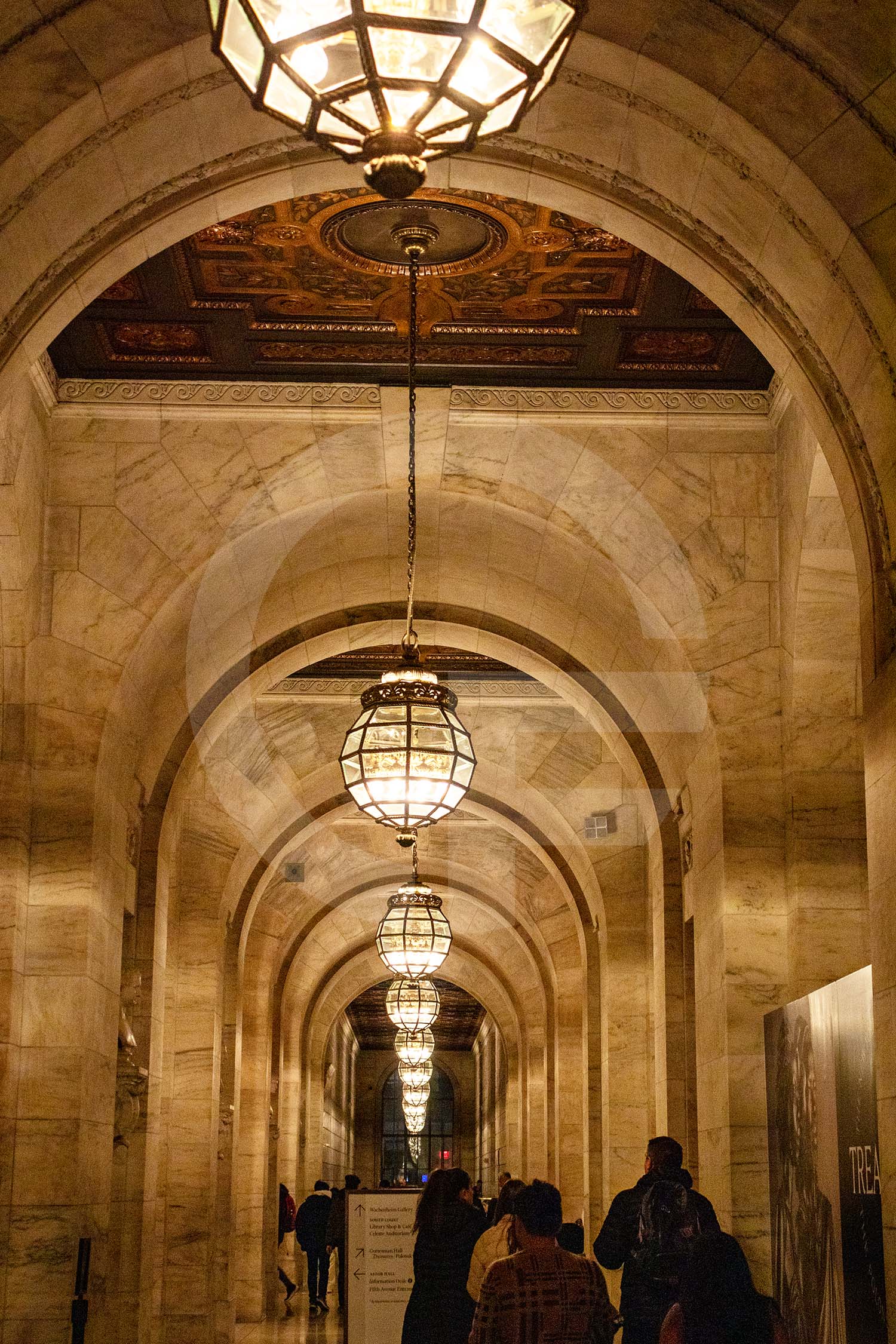 hallway with chandeliers and ceiling with ornate patterns